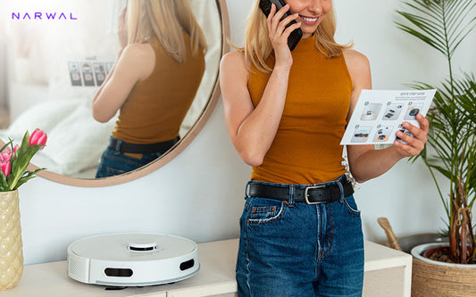 A woman setting up a Narwal robot vacuum