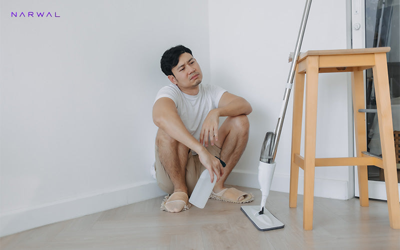 Tired man taking a break from mopping